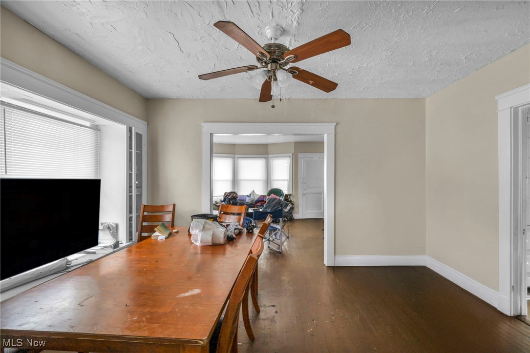 738 Eddy Road Cleveland, OH 44108 - Photo 22 of 33 Dining space featuring a textured ceiling, a ceiling fan, and dark wood-type flooring