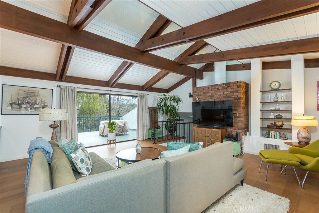 3611 El Lado Drive Glendale, CA 91208 - Photo 16 of 31 a living room with fireplace furniture and a large window