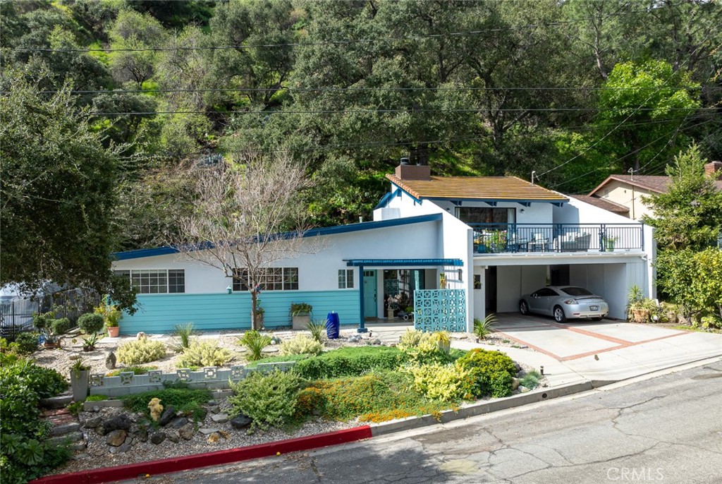 3611 El Lado Drive Glendale, CA 91208 - Photo 3 of 31 a front view of a house with a yard and potted plants