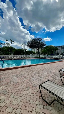 a kitchen with stainless steel appliances granite countertop a refrigerator and a stove
