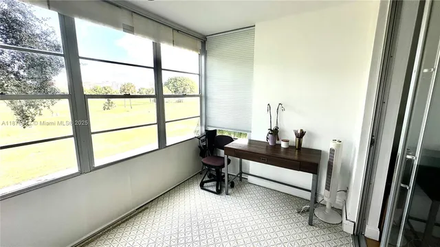 a view of a workspace room with wooden floor and a bathroom