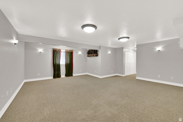 4792 Glasmann Way South Ogden, UT 84403 - Photo 57 of 70 Spacious room featuring neutral carpeting and light gray walls with lots of natural light