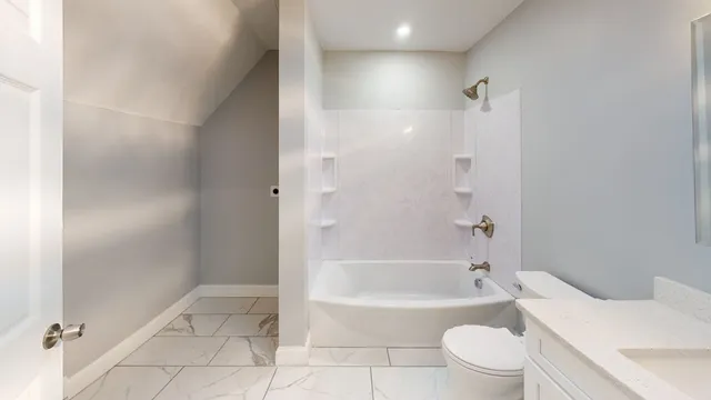 a bathroom with a bathtub toilet and sink