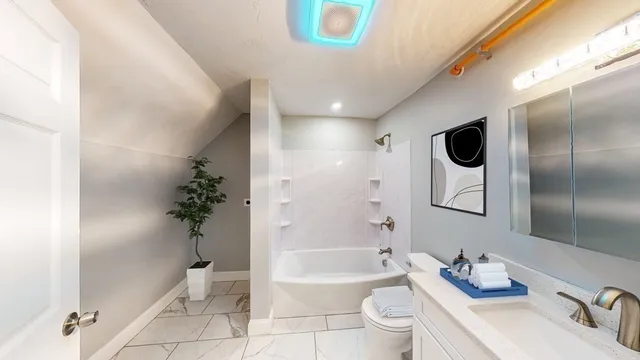 a bathroom with a bathtub shower sink and toilet
