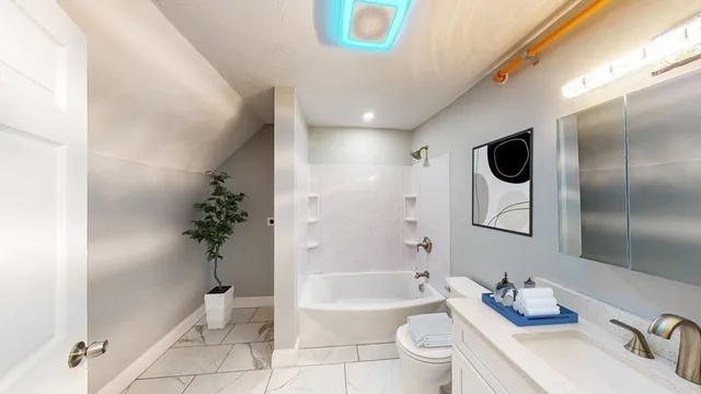 a bathroom with a bathtub shower sink and toilet