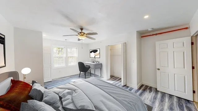 a spacious bedroom with a bed and a window