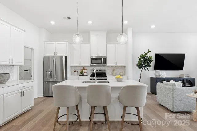 a view of kitchen with refrigerator dining table and chairs