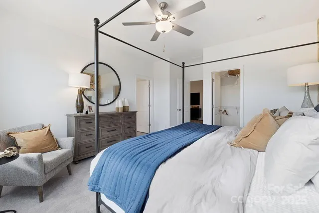 a bed room with a bed and a chandelier