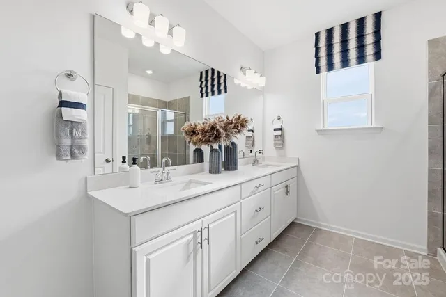 a bathroom with a double vanity sink and a mirror