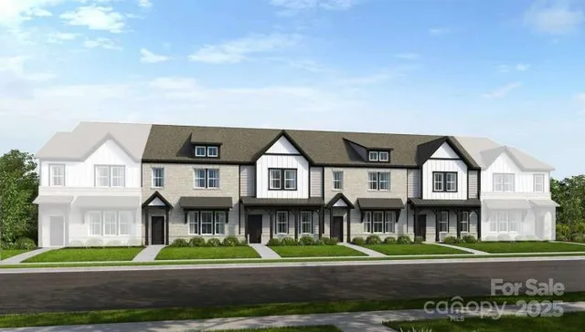 a front view of a residential apartment building with a yard