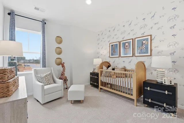 a bedroom with furniture and a lamp