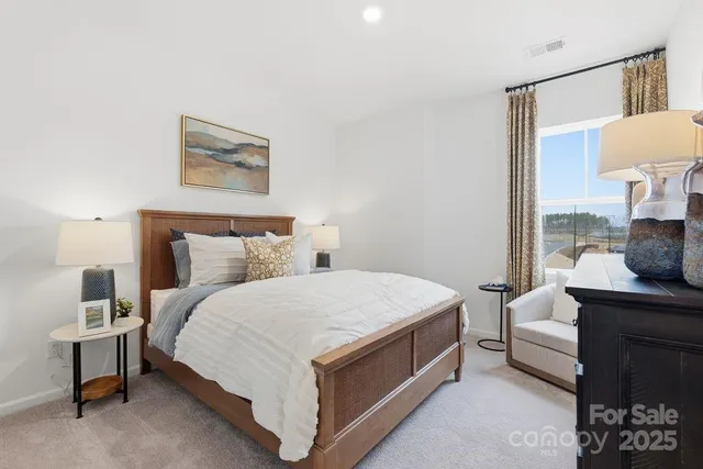 a bedroom with a bed wooden floor and lamp