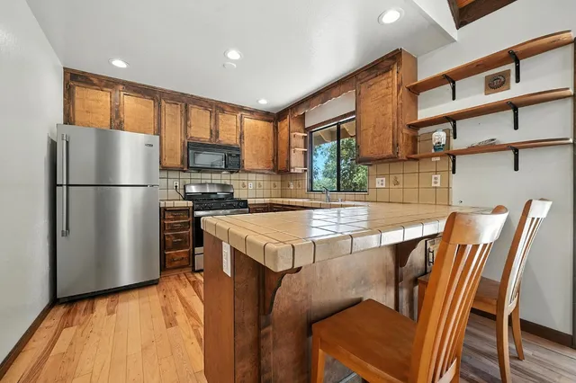 a bathroom with a sink a large mirror and a bathtub