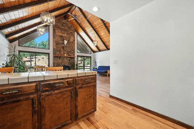 a bathroom with a granite countertop sink a large mirror and a shower