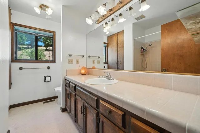 a view of a room with furniture and a window