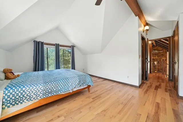 a backyard of a house with a fountain and large trees
