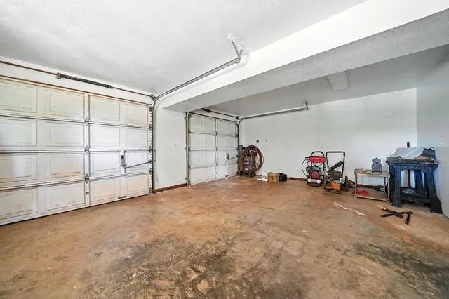 a view of a yard covered with snow in front of house