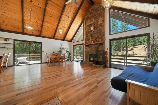 a dining room with furniture water view and wooden floor