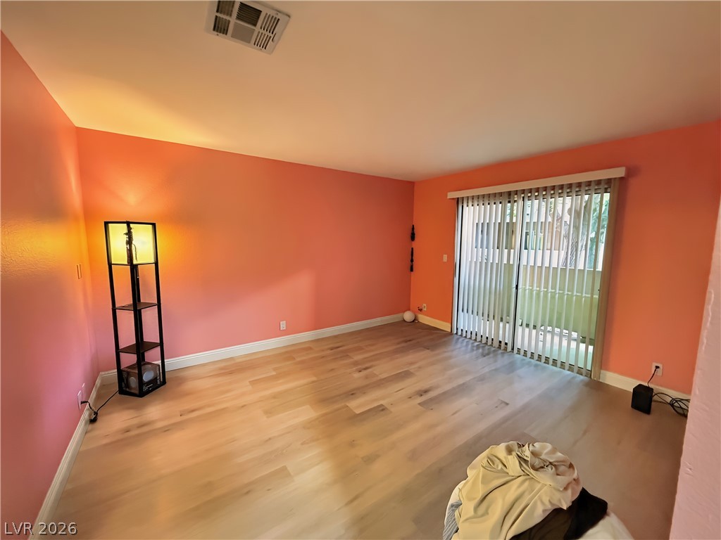 1852 North Decatur Boulevard, Unit 101 Las Vegas, NV 89108 - Photo 40 of 45 Smooth wood floors and sliding glass doors define this versatile living space.
