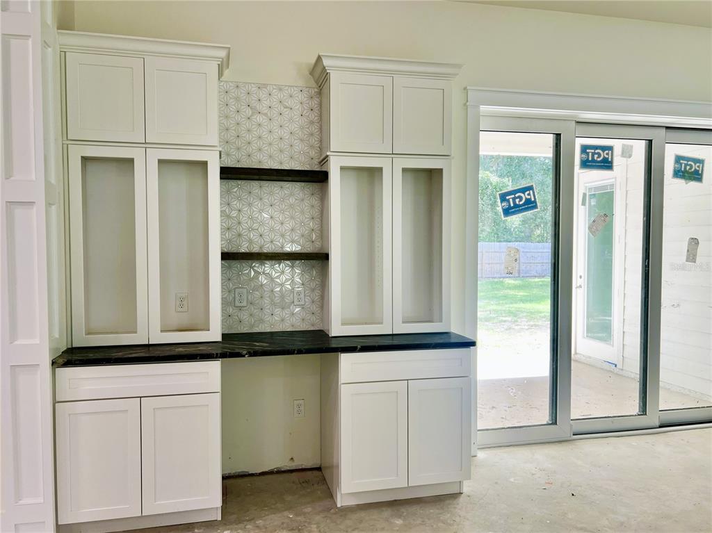 3189 Northwest 135th Way Gainesville, FL 32606 - Photo 13 of 16 a view of a kitchen with granite countertop cabinets