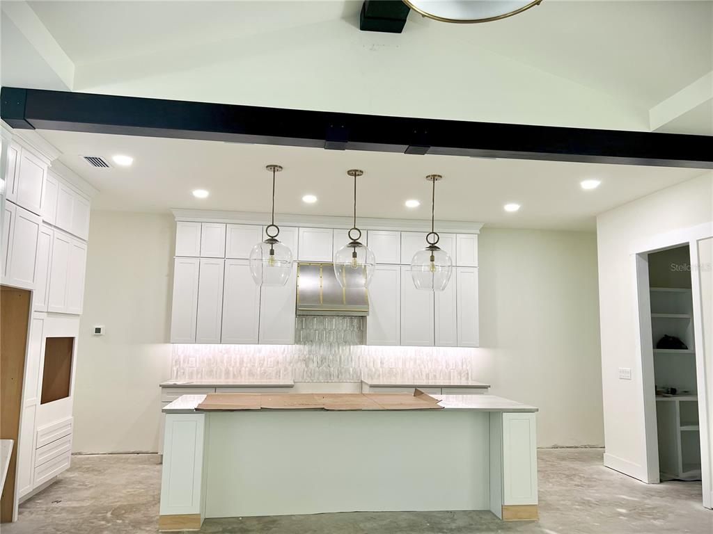 3189 Northwest 135th Way Gainesville, FL 32606 - Photo 15 of 16 a kitchen with stainless steel appliances granite countertop a sink and a refrigerator