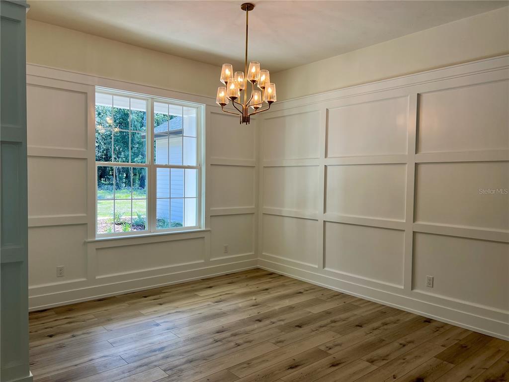 3189 Northwest 135th Way Gainesville, FL 32606 - Photo 2 of 16 a view of a room with wooden floor and windows