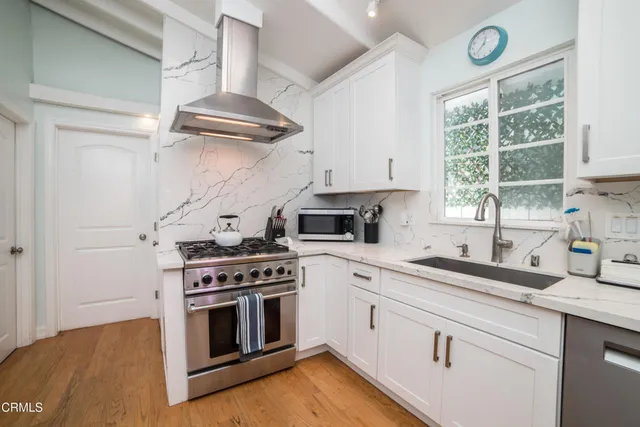 a kitchen with cabinets appliances and a window