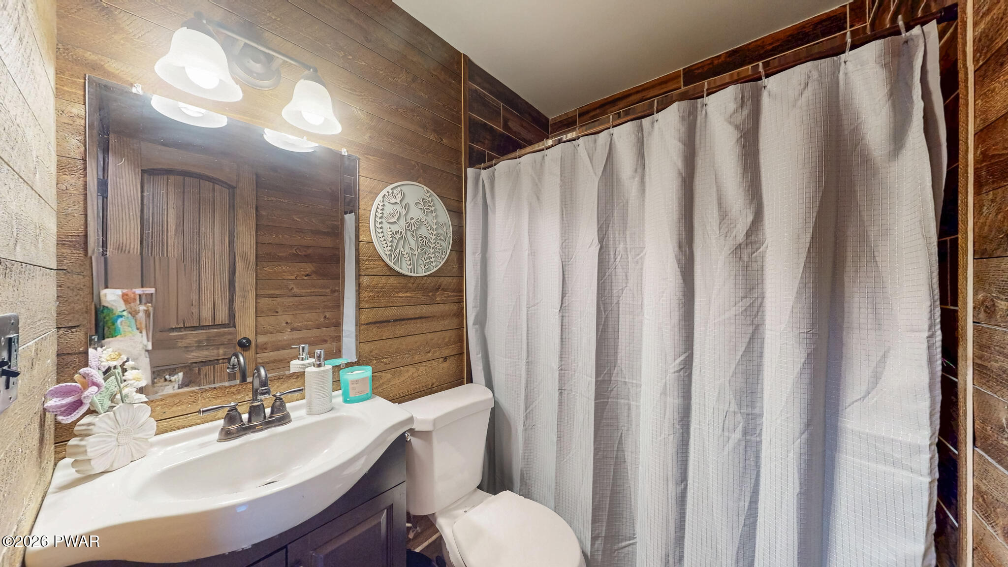 149 Sheards Road Milanville, PA 18443 - Photo 41 of 57 a bathroom with a sink mirror and toilet