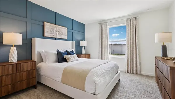 a bedroom with a bed and a lamp