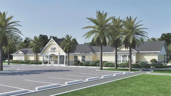 a view of multiple houses with a yard and palm trees