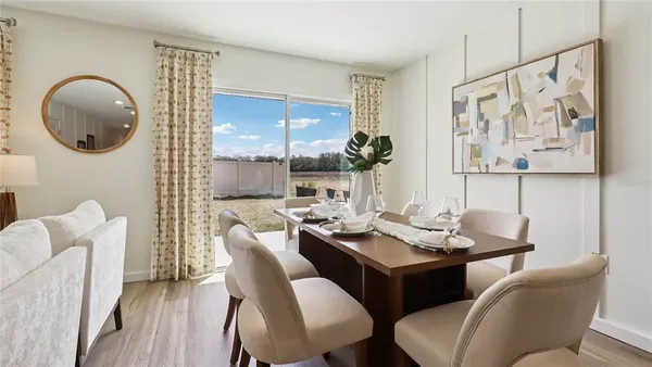 a dining room with furniture and window