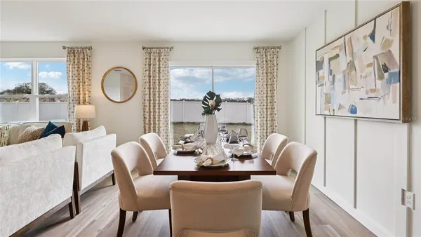 a dining room with furniture a window and wooden floor