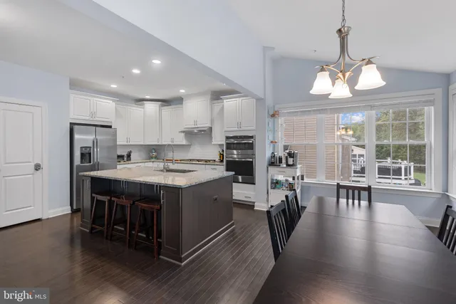 a living room with furniture a fireplace and a large window