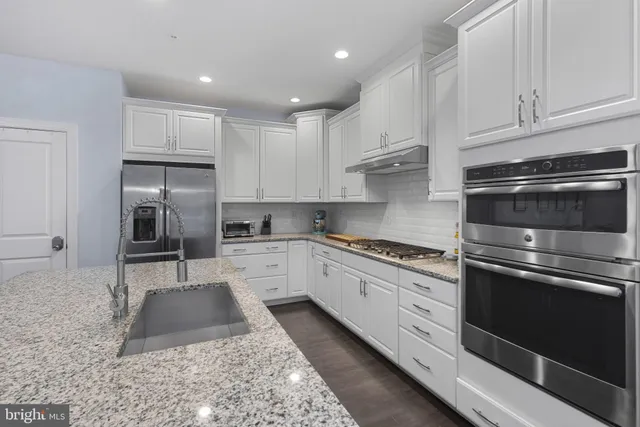 a living room with furniture a fireplace and a large window
