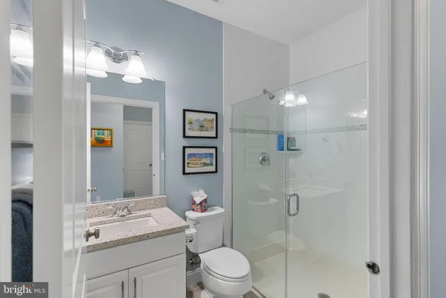 a spacious bedroom with a bed and a flat screen tv