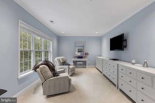 a bedroom with a bed and a dresser in it