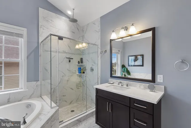 a utility room with dryer washer and a window