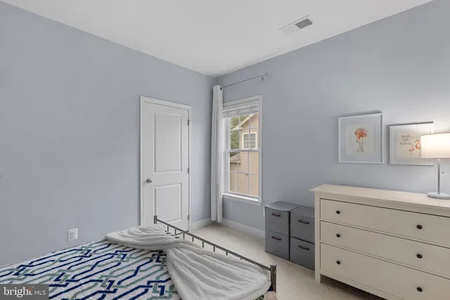 a bathroom with a sink vanity mirror and toilet