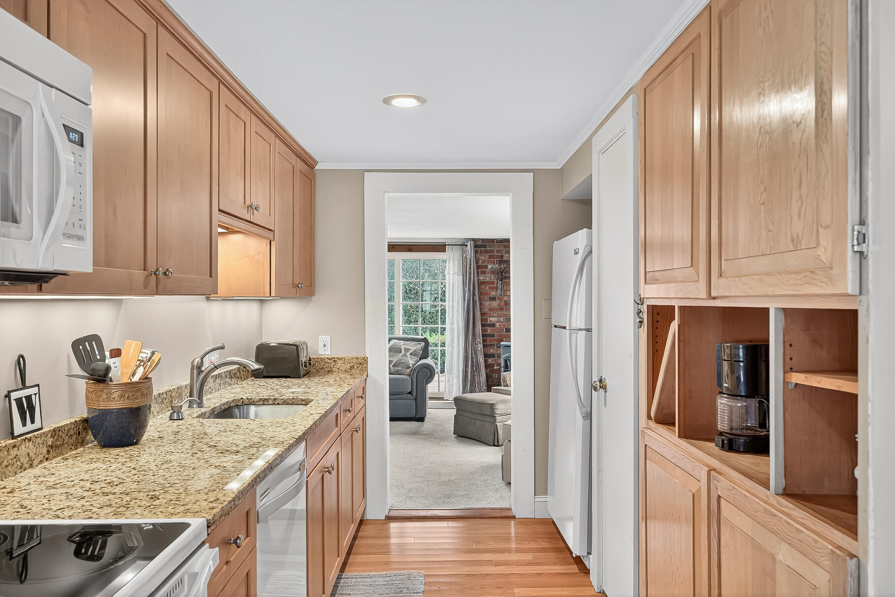 87 Spring Street Hyannis, MA 02601 - Photo 6 of 27 a kitchen with stainless steel appliances granite countertop a sink stove and cabinets