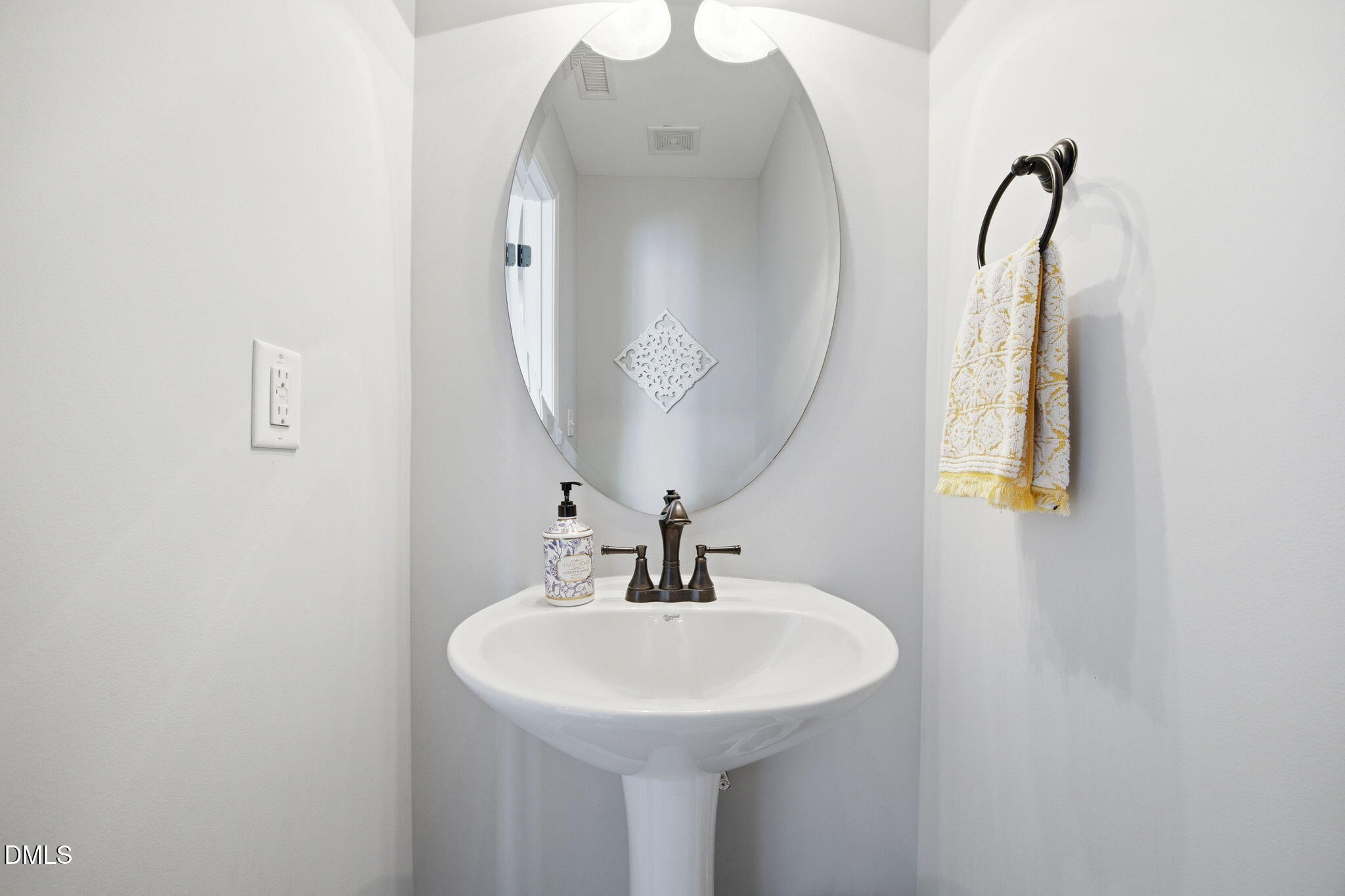 2827 Corbett Grove Drive Raleigh, NC 27616 - Photo 29 of 49 a bathroom with a sink and a mirror