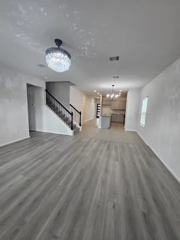 a view of a room with wooden floor