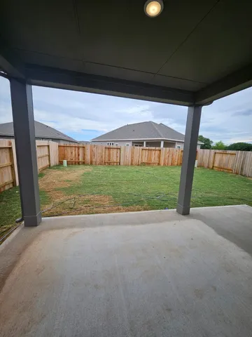 a view of a house with backyard and porch