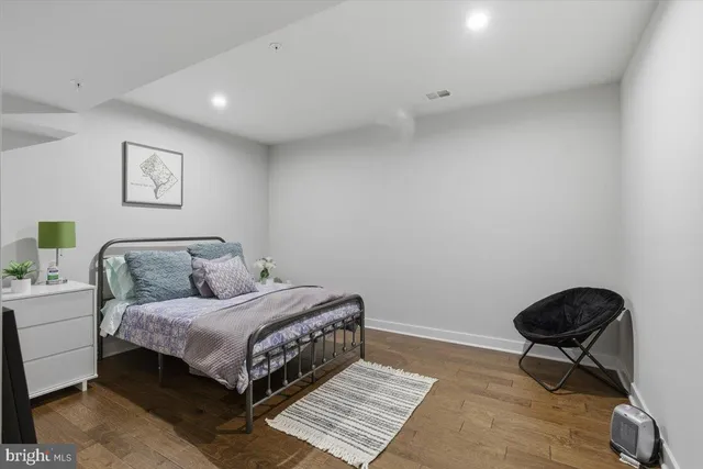 a bedroom with a bed and a chair in it