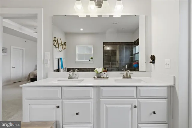 a bathroom with a sink vanity and mirror