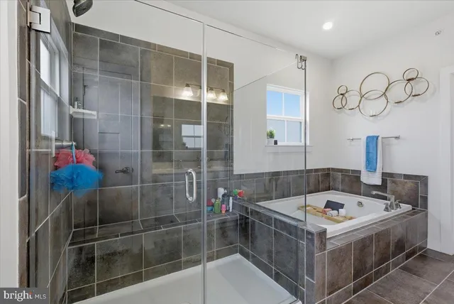 a bathroom with a bathtub and a shower