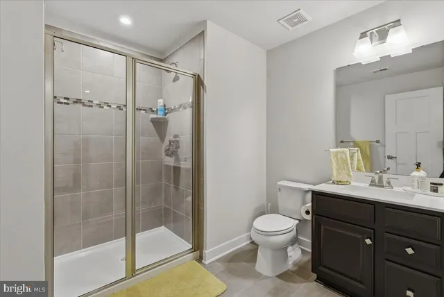 a bathroom with a toilet a sink and a mirror
