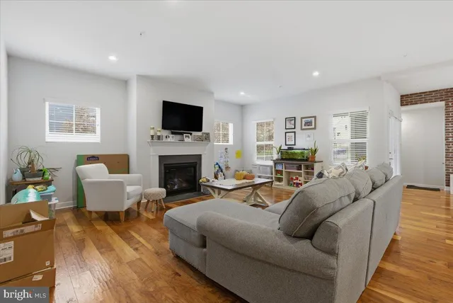 a living room with furniture a flat screen tv and a fireplace