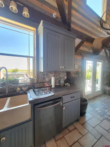 a kitchen with stainless steel appliances a sink stove and cabinets