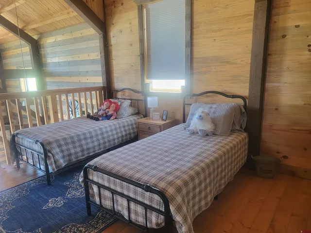 a bed sitting in a bedroom next to a bathroom