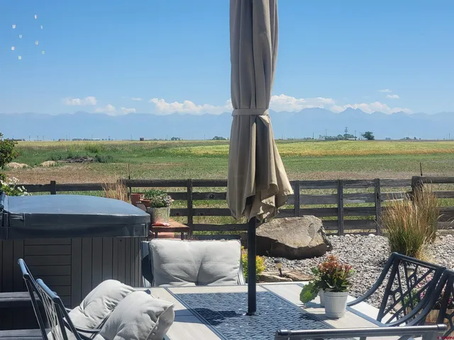 a view of a lake with couches in patio